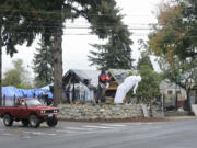 A vehicle waits to turn the corner at Northeast 112th and Northeast Rosewood avenues near Covington Middle School on Oct. 18. Code enforcement has cited the property owner for, among other things, junk piled up along the road, making it difficult for drivers to see and safely turn.