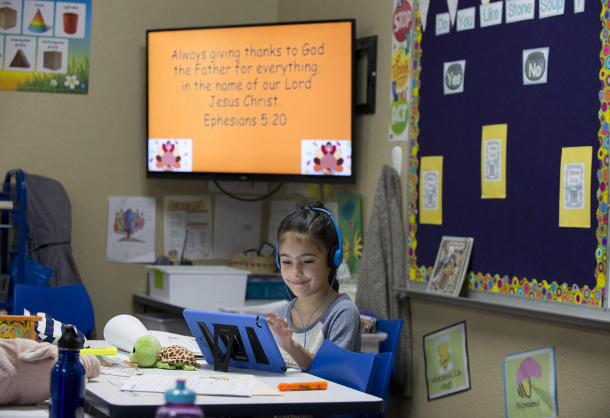 First-grader Rebeckah Pravettoni, 6, learns using a tablet at Cornerstone Christian Academy on Thursday morning.