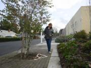 Cara Cottingham walks along the deteriorating sidewalk on Fairmount Avenue between East Fourth Plain Avenue and East 20th Street, where part of the sidewalk has deteriorated to a point where people in wheelchairs can&#039;t use them.