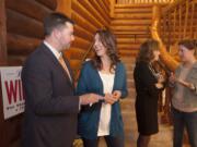 Candidates Brandon Vick, from left, Jaime Herrera Beutler, Lynda Wilson and Ann Rivers chat after taking a group photo at Summit Grove Lodge in Ridgefield on Tuesday night.