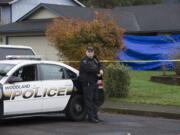 Officer Rudy Podhora keeps watch at the scene of a homicide in Woodland on Nov. 22, 2016.  Dustin Alan Griffin was arrested on suspicion of first degree murder in the death of Donald William Howard.