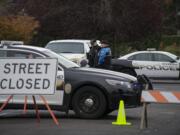 Officer Rudy Podhora, left, talks with Officer Jim Keller at the scene of a possible homicide in Woodland on Tuesday morning.