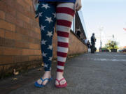 Vancouver resident Eliza Smith shows her patriotic spirit outside the Clark County Elections Office on Tuesday afternoon.