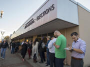 Battle Ground resident Craig Dearnaley, right, joins a long line of residents outside the Clark County Department of Elections as he prepares to vote Nov. 8.