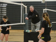 Coach Jeff Nesbitt demonstrates proper posture to Woodland volleyball players during practice at Woodland High School, Wednesday November 9, 2016.