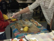 Landover-Sharmel: Anna Weyrauch, a nutrition educator at Washington State University Extension&#039;s Supplemental Nutrition Assistance Program Education, at Endeavour Elementary School for the school&#039;s Harvest of Month campaign, where educators visit elementary schools to help students try new, fresh foods at lunch.