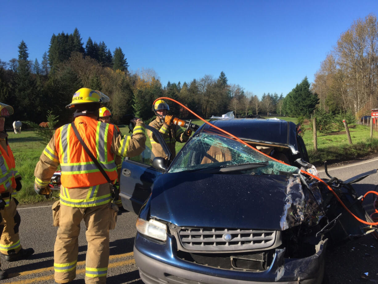 Firefighters cut open a vehicle involved in a crash near Battle Ground that sent a 70-year-old man to the hospital Tuesday morning.