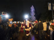 Santa Claus greets a large crowd of spectators after helping to light the tree at Esther Short Park on Friday night.