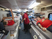 Jason Hutchinson, left, and Mitch Taylor, right, donate blood Wednesday in honor of Lyn Hutchinson -- Jason Hutchinson&#039;s father and Taylor&#039;s colleague -- who was diagnosed with a glioblastoma brain tumor in August and given three to five months to live. Lyn Hutchinson had donated 19 gallons of blood to the American Red Cross before his health took a turn, so his colleagues at Columbia Ultimate in Vancouver held a blood drive to help Hutchinson reach his 20-gallon donation goal.