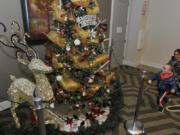 Desmond Wood and his mother, Cindy Wood, chat up the Talking Tree, a popular feature at the Festival of Trees.