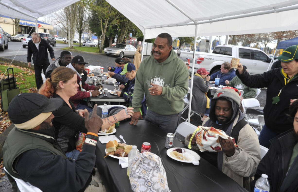 Donnie Vercher, center, said food brings people together, which is why when he wanted to give back to the community he decided to host a free Thanksgiving meal for the homeless. His fifth annual meal, which took place on Saturday, saw more than 400 people come to his restaurant, Daddy D&#039;s BBQ, located in the back of a gas station.