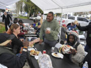 Donnie Vercher, center, said food brings people together, which is why when he wanted to give back to the community he decided to host a free Thanksgiving meal for the homeless. His fifth annual meal, which took place on Saturday, saw more than 400 people come to his restaurant, Daddy D&#039;s BBQ, located in the back of a gas station.