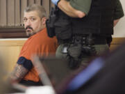 Brent Luyster, the man accused in the Woodland triple-homicide, waits to be called forward during his hearing Tuesday, Nov. 8 in Clark County Superior Court. Luyster's arraignment was pushed back for a third time Tuesday.