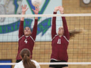 Prairie's Megan Hess (4) and Abby Brotherton (11) play the net during the Falcons' win over Kelso.