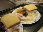 Classic dishes fill plates at a free Thanksgiving 2015 supper at the Proto-Cathedral of St. James, 218 W. 12th St., Vancouver. The church offers a free meal every Thursday evening in honor of Blessed Pier Giorgio Frassati.