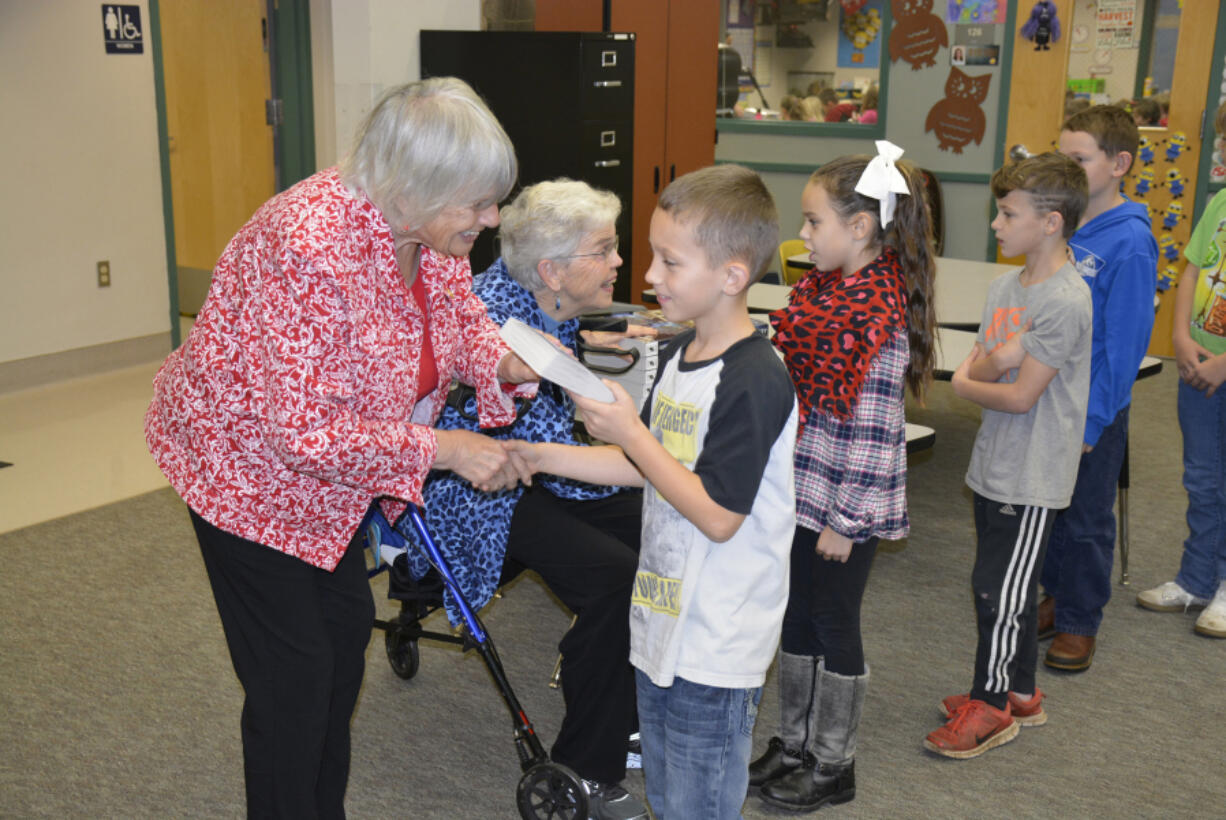 Washougal: Camas-Washougal Rotary Club members Joyce Lindsay, left, and Nan Henriksen hand out dictionaries to Cape Skye-Horn Elementary School students Mycal Allen, from left, Chloe Cianni, Cohen Nortam and Braxton Swanson.