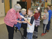 Washougal: Camas-Washougal Rotary Club members Joyce Lindsay, left, and Nan Henriksen hand out dictionaries to Cape Skye-Horn Elementary School students Mycal Allen, from left, Chloe Cianni, Cohen Nortam and Braxton Swanson.