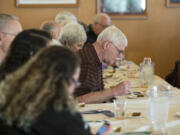 Lloyd Goodpaster of Vancouver, center, tries a slice of reduced-carbohydrate pumpkin pie during a cooking class on diabetic-friendly foods for the holidays Thursday afternoon at Legacy Salmon Creek Medical Center. The diabetic-friendly pie, which uses an almond and walnut crust, has 19 grams of carbs, as opposed to 42 grams in a more traditional pumpkin pie.