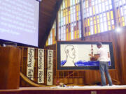 Vancouver art teacher Jeffrey Thompson paints a picture before the congregation at First Presbyterian Church in Vancouver on Oct. 16. Thompson and Rev. Josh Rowley collaborated for the fourth time to illustrate a sermon as it is preached.