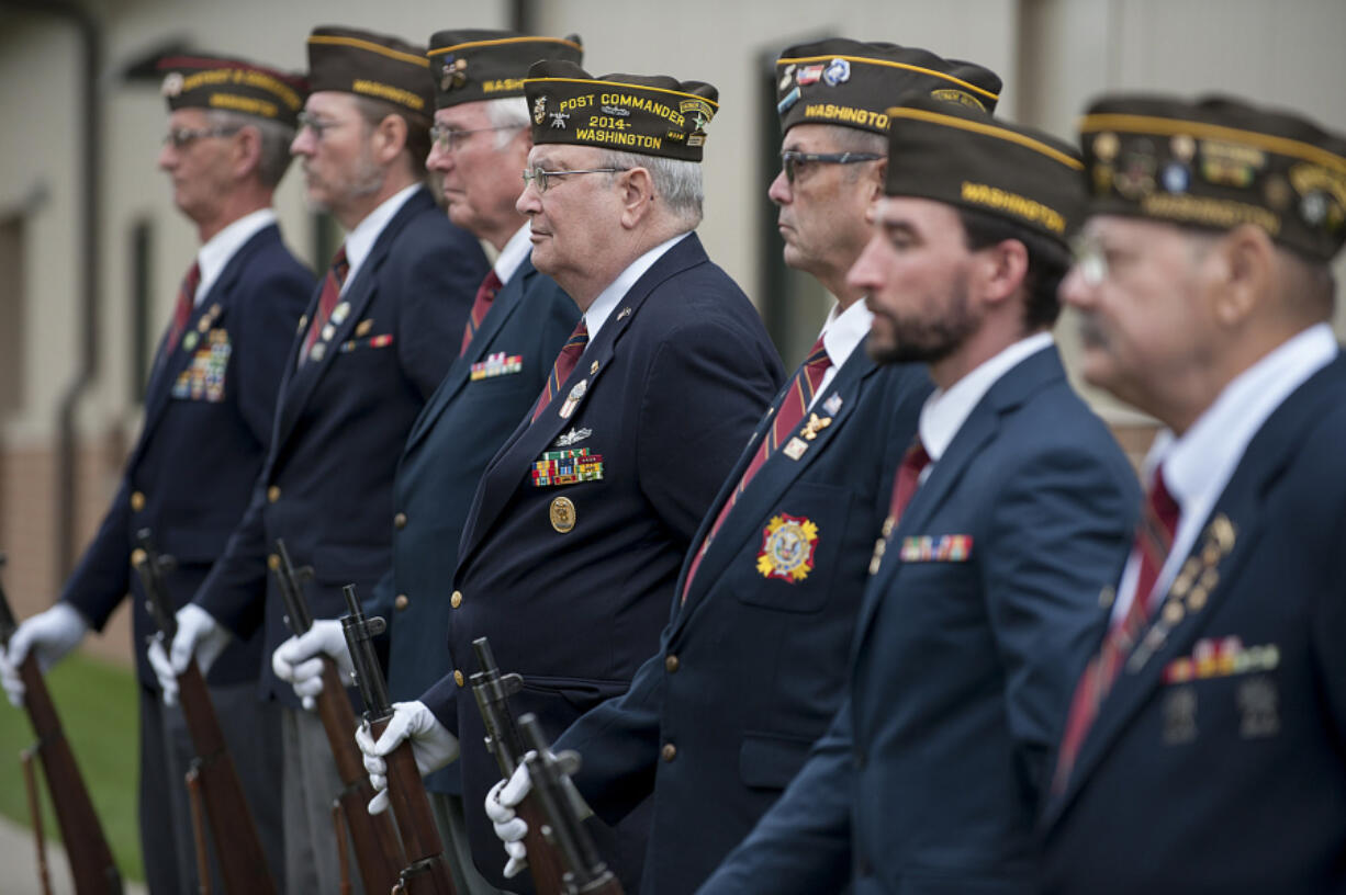 Members of the Veterans of Foreign Wars Post 7824 honor guard prepare to give a rifle salute during the Veterans Day observance Friday at the Armed Forces Reserve Center.