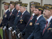 Members of the Veterans of Foreign Wars Post 7824 honor guard prepare to give a rifle salute during the Veterans Day observance Friday at the Armed Forces Reserve Center.