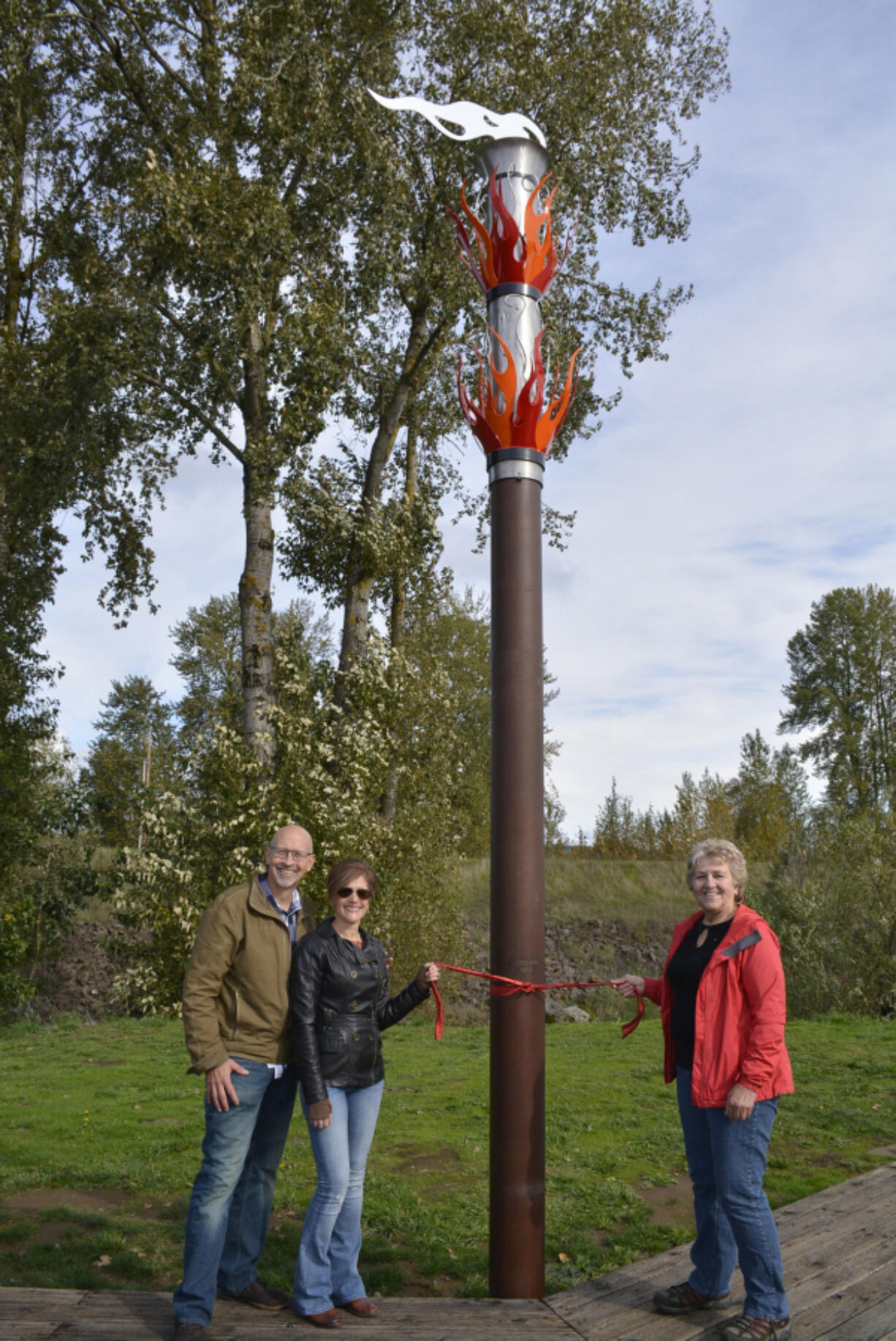 Washougal: Married couple Dave Frei, from left, and Jennifer Corio with Molly Coston, who donated money so the couple could build their &quot;Fire&quot; sculpture as part of Washougal&#039;s &quot;Elements&quot; series of public artwork displayed around the city.