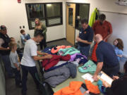 Lake Shore: Firefighters from Clark County Fire District 6 fit students at Eisenhower Elementary School for jackets as part of Operation Warm.