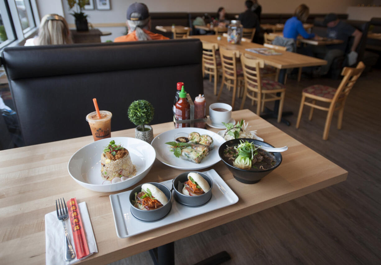 Pork fried rice, clockwise from upper left, is served Oct. 31 with Saigon rolls with chicken, Thai boat noodles and Asian steamed buns with pork at Eight Noodles in Salmon Creek.