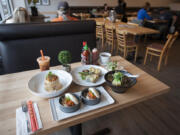 Pork fried rice, clockwise from upper left, is served Oct. 31 with Saigon rolls with chicken, Thai boat noodles and Asian steamed buns with pork at Eight Noodles in Salmon Creek.