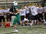 Glen Perry Jr. (23) of Mountain View, runs with the ball as he is pursued by Bishop Blanchet&#039;s Jamiek Satterwhite. Perry had 174 yards rushing and three TDs Saturday.