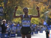 Ghirmay Ghebreslassie, of Eritrea, reacts as he crosses the finish line first in the men's division of the 2016 New York City Marathon in New York, Sunday, Nov. 6, 2016.