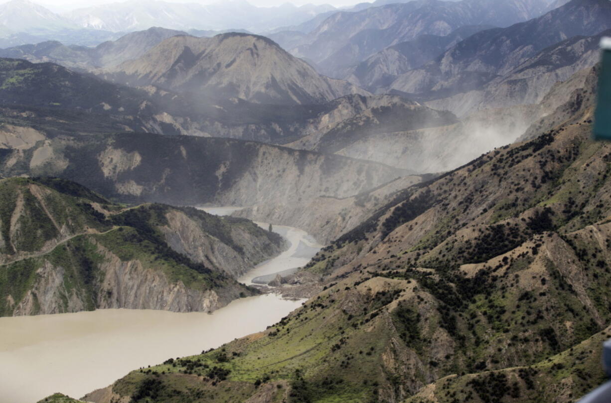 Dust created by a strong aftershock Monday hangs above the Clarence River, which was blocked following a magnitude-7.8 earthquake north of Kaikoura, New Zealand.