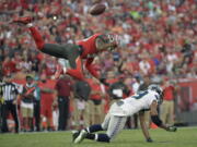 Seattle Seahawks wide receiver Doug Baldwin (89) loses the football as he is hit by Tampa Bay Buccaneers free safety Bradley McDougald (30) during the second quarter of an NFL football game Sunday, Nov. 27, 2016, in Tampa, Fla. McDougald was called for a pass interference penalty.