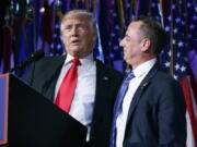 President-elect Donald Trump, left, stands with Republican National Committee Chairman Reince Priebus during an election night rally in New York. Trump on Sunday named Priebus as his White House chief of staff.