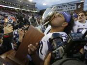 Washington defensive lineman Vita Vea kisses the Apple Cup trophy after Washington beat Washington State, 45-17, in an NCAA college football game, Friday, Nov. 25, 2016, in Pullman, Wash. (AP Photo/Ted S.