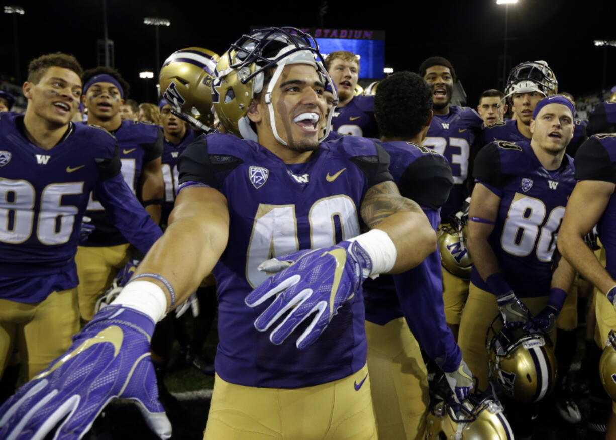 Washington running back Ralph Kinne (40) or Washington State receiver John Thompson could be celebrating a very big win Friday in the Apple Cup game in Pullman.