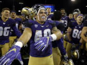 Washington running back Ralph Kinne (40) or Washington State receiver John Thompson could be celebrating a very big win Friday in the Apple Cup game in Pullman.