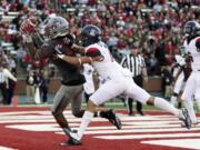 Washington State wide receiver Tavares Martin Jr. (8) catches a pass for a touchdown while defended by Arizona cornerback Jace Whittaker.