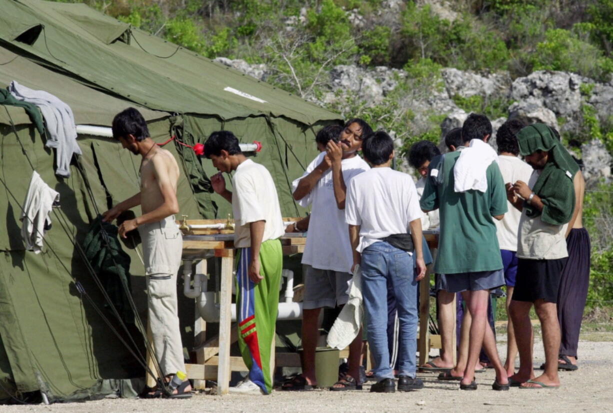 Men shave, brush their teeth and prepare for the day Sept. 21, 2001, at a refugee camp on the Island of Nauru. The United States and Australia are close to announcing a deal in which the U.S. would resettle hundreds of asylum seekers banished by Australia to Pacific island camps, a newspaper reported on Friday. The U.S. had agreed to accept up to 1,800 refugees held for up to three years at Australia&#039;s expense in camps on the impoverished island nations of Nauru and Papua New Guinea, The Australian newspaper reported.