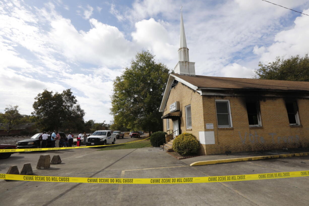 Area residents and church members watch Wednesday as authorities investigate the fire at Hopewell M.B. Baptist Church in Greenville, Miss. (ROGELIO V.