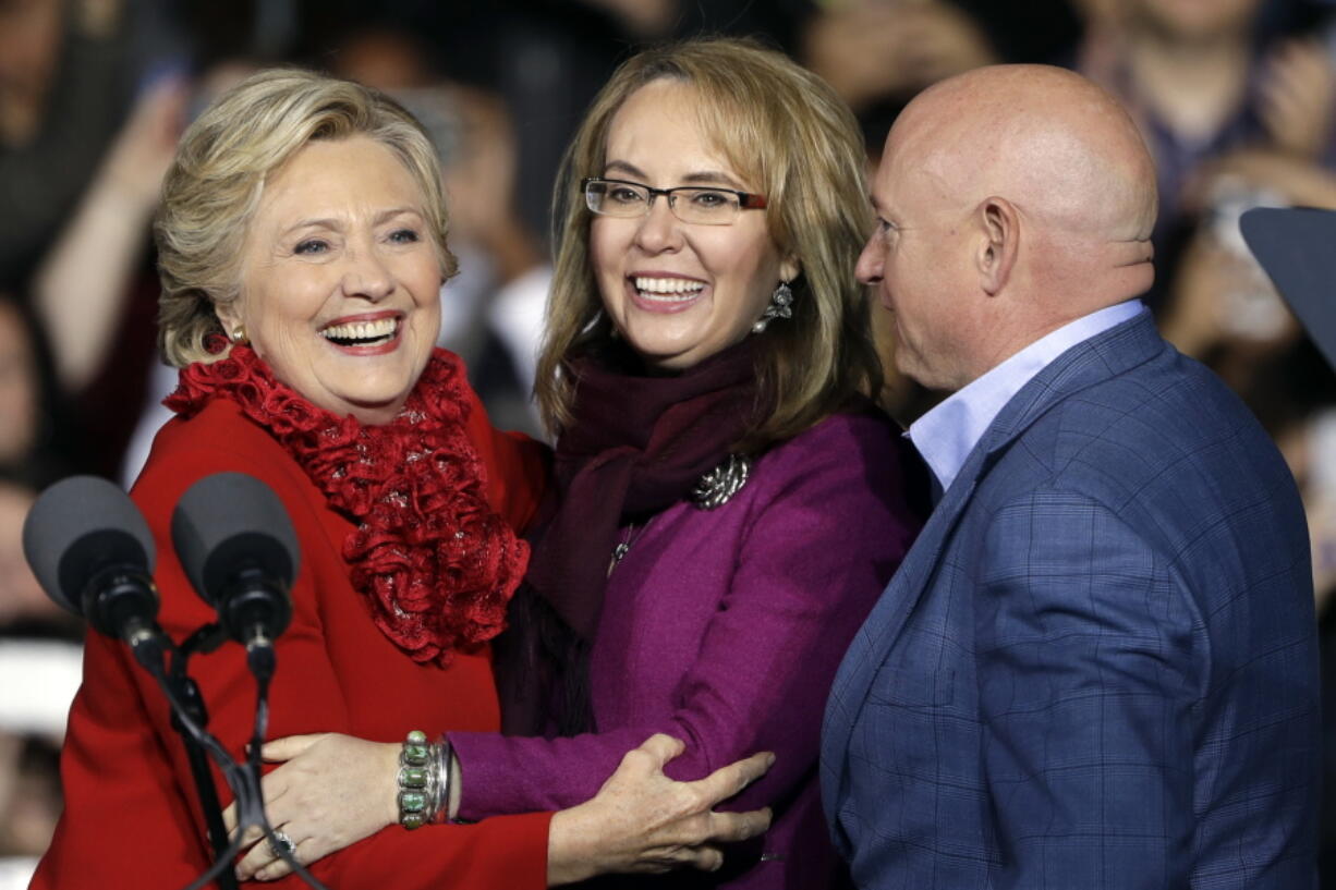 Democratic presidential candidate Hillary Clinton campaigns with former Arizona Rep. Gabby Giffords and her husband Mark Kelly at the base of the John A. Roebling Suspension Bridge in Cincinnati on Monday.