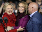 Democratic presidential candidate Hillary Clinton campaigns with former Arizona Rep. Gabby Giffords and her husband Mark Kelly at the base of the John A. Roebling Suspension Bridge in Cincinnati on Monday.