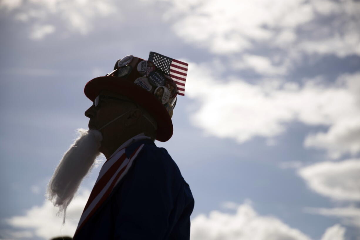 Will Enderley, dressed in costume, waits for the start of a Donald Trump rally Wednesday in Orlando, Fla.