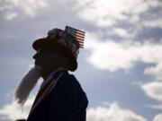 Will Enderley, dressed in costume, waits for the start of a Donald Trump rally Wednesday in Orlando, Fla.