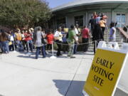 Voters line up during early voting at Chavis Community Center in Raleigh, N.C. More than a dozen states have enacted tougher requirements for registering and voting since the U.S. Supreme Court overturned a key provision of the Voting Rights Act three years ago. That has led to confusion and claims that certain groups, mostly minorities who tend to vote with Democrats, are being disenfranchised.