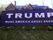 As the sun sets, a giant Trump campaign yard sign nearly dwarfs the Antico family, six-bedroom home in Wayland, Mass., Tuesday, Nov. 1, 2016. The sign, which was erected in early Spring 2016, is about fifty feet long. Campaign signs have been a thing since the early 1800s. Political scientists question the effectiveness of yard signs, at least in presidential politics.