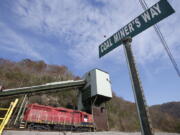 A road sign is posted at the entranced the closed Spruce Creek coal mine in Matewan, W.Va., on Friday. The hard-eyed view along the Tug Fork River in coal country is that Donald Trump has to prove he&#039;ll help Appalachian mining like he promised.