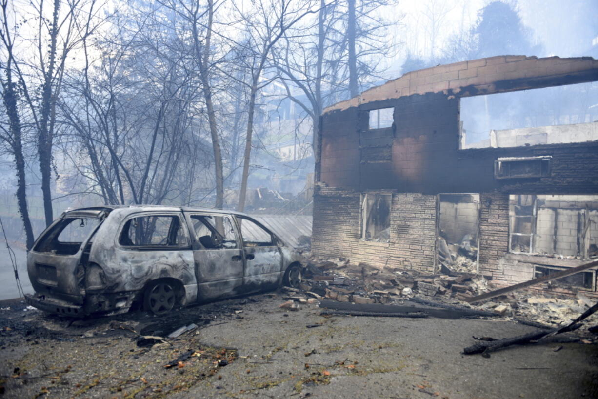 A home and vehicle are damaged from the wildfires around Gatlinburg, Tenn., on  Tuesday.  Rain had begun to fall in some areas, but experts predicted it would not be enough to end the relentless drought that has spread across several Southern states and provided fuel for fires now burning for weeks in states including Tennessee, Georgia and North Carolina.