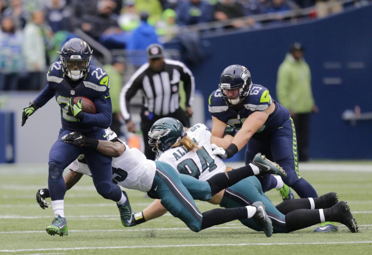 Seattle Seahawks running back C.J. Prosise (22) is tackled by Philadelphia Eagles outside linebacker Nigel Bradham, second from left, in the first half of an NFL football game, Sunday, Nov. 20, 2016, in Seattle.