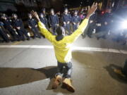 A protester pleads with police Wednesday in Oakland, Calif. Police in Oakland blocked thousands of people protesting Donald Trump&#039;s election from getting onto a highway Wednesday night. The crowd chanting and waving signs gathered in Frank Ogawa Plaza in downtown Oakland in the afternoon.